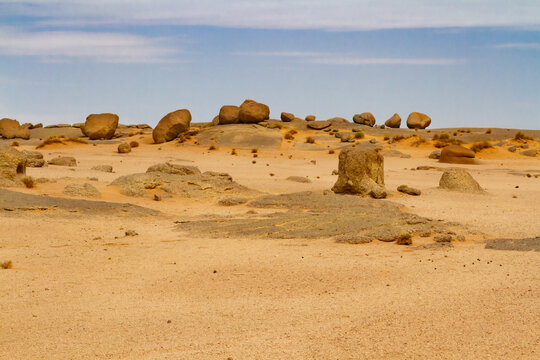 Sahara landscape. Rock formations with large, round boulders on a dune and rocks. Tassili n'Ajjer National Park, Algeria, Africa