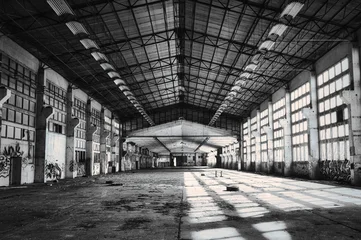 Fototapeten Verlassene Gebäude Abandoned industrial factory hall in black and white with dramatic light - reportagefotografie - dokumentarisch - real photography - camera shot,- no ai -  human made  © Enrico Obergefäll