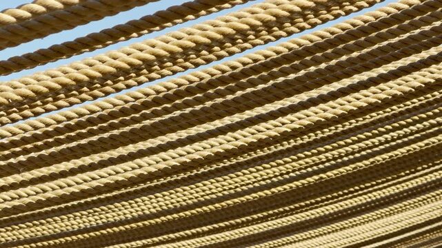 A thick layer of rustic ropes stretches tightly overhead to provide cooling shade. The dense, natural pattern creates a cozy and sheltered feeling under the bright summer sky.