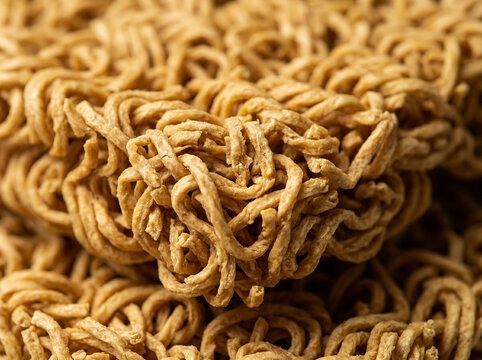 Close-up macro photograph of dry instant ramen noodles, a popular food staple
