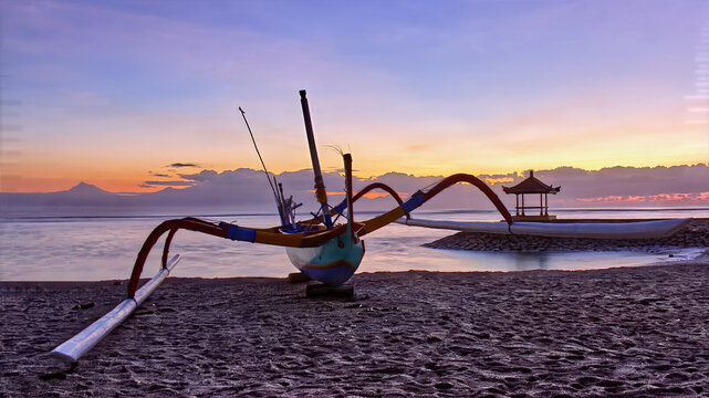 Traditional Jukung boat on the beach at sunrise, Bali, Indonesia