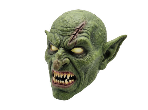Green goblin mask with sharp teeth and yellow eyes isolated on transparent background