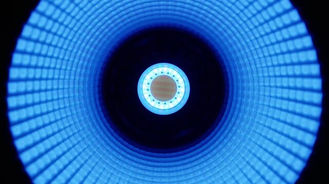 A close-up view of a glowing cyan ring light with concentric circular patterns and a central diode cluster. Concept of futuristic technology, cybernetic vision, and digital illumination systems.