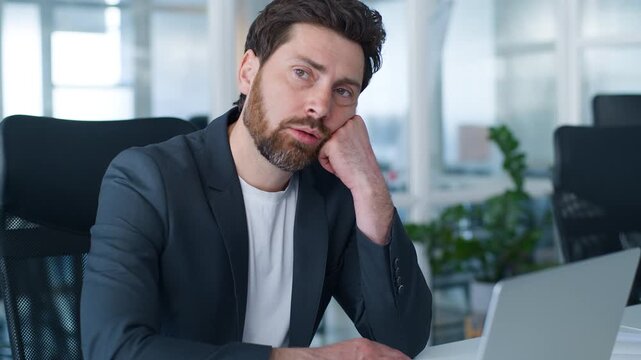Lazy sad exhausted Caucasian business man boring with laptop hard work suffering with boredom office burnout problem European middle-aged businessman looking in computer with upset bad mood male clerk