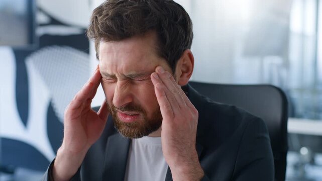 Caucasian ill sick middle-aged business man with headache rubbing head temples businessman thinking bad feeling blood pressure work tension mature male think suffer migraine health ache pain in office