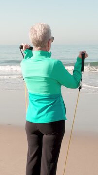 71 year old woman gets her exercise at the beach in Southern California. Slow Motion. Vertical Video.