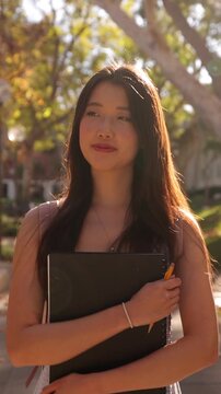 Asian female college student walking to her class. Vertical Video.