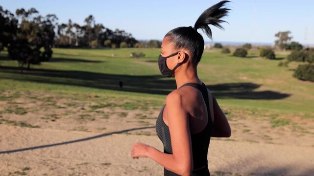 Mixed ethnicity (Asian-African) woman jogging in the park