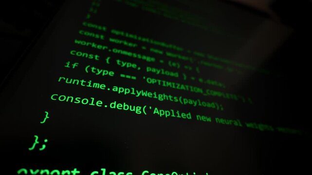 Green automated programming code generating on a dark computer monitor screen. The display illustrates the modern concept of artificial intelligence writing software scripts.