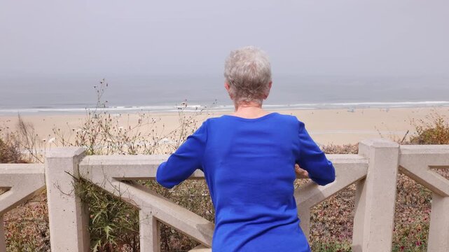 Senior woman gets her morning exercise at a park overlooking the Santa Monica beach.