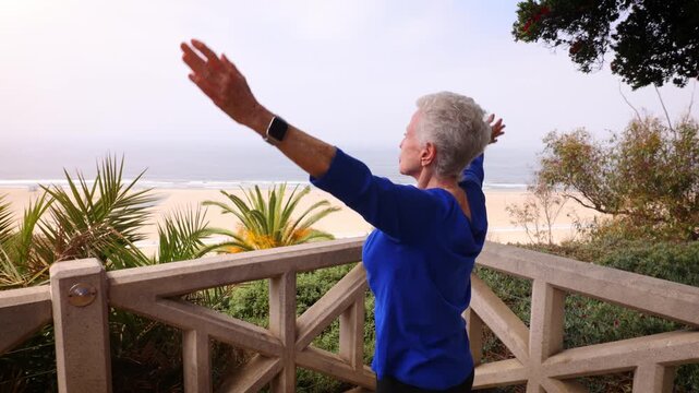 Senior woman gets her morning exercise at a park overlooking the Santa Monica beach.