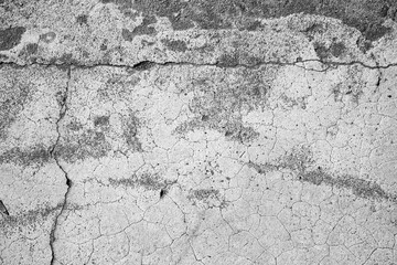 Obraz premium Cracked concrete surface with rough texture and age lines