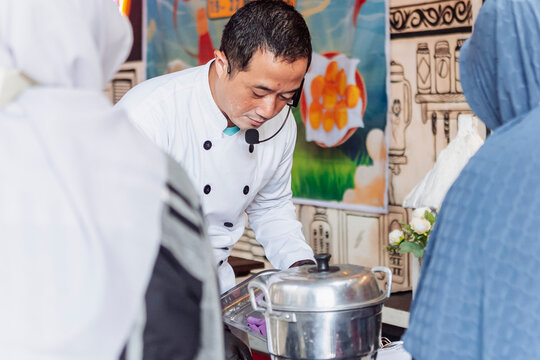 Chef teaching multicultural cooking skills to students