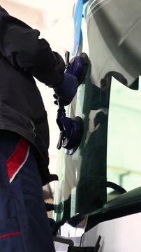 Close-up of car windshield replacement with suction cups
