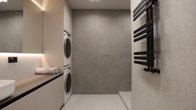 Compact Laundry With Storage. Minimalist Bathroom Featuring Builtin Storage And Heated Walls