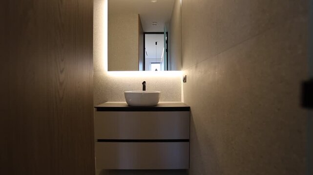 Soothing Warm Light Draws Focus Toward Refined Mirror And Simple Oak Paneling In Luxury Setting