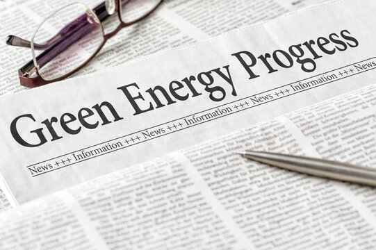A newspaper with the headline Green Energy Progress