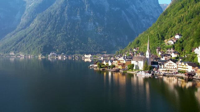 Drone View of Picturesque Lakeside Town Hallstatt with Layered Alp Mountains towering above. Warm Summer Morning. Salzkammergut, Austria UNESCO heritage site