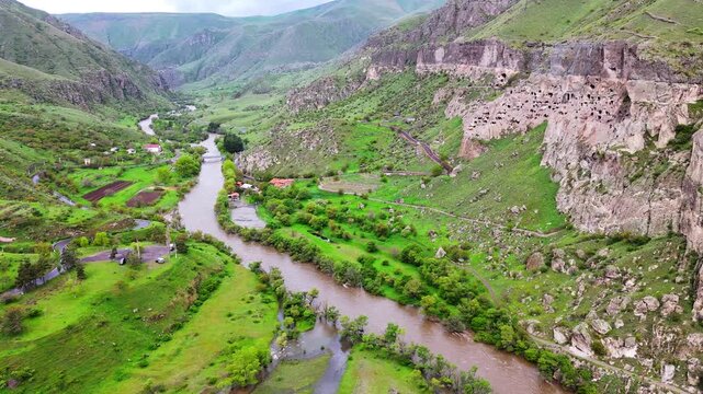 aerial of Vardzia holy cave monastery complex and Mtkvari River canyon, Georgia  caucasian mountains