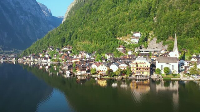 Drone View of Picturesque Lakeside Town Hallstatt with Layered Alp Mountains towering above. Warm Summer Morning. Salzkammergut, Austria UNESCO heritage site