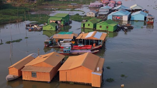 Close aerial orbit of floating houses and boats, Chau Doc, Vietnam