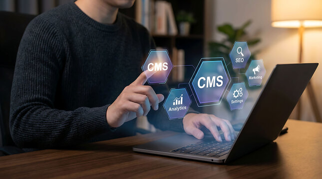 Man interacting with digital CMS icons on laptop screen in cozy office