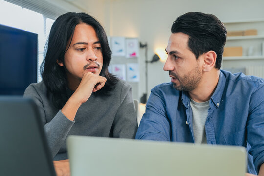 Two Serious Computer Programmers Coding on Screen Close-up Portrait of Software Engineers Writing Source Code and Developing Application Indoors