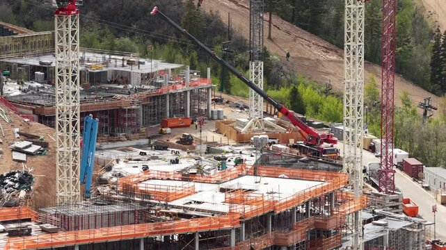 Aerial tight shot of construction and cranes in Utah in Park City mountains
