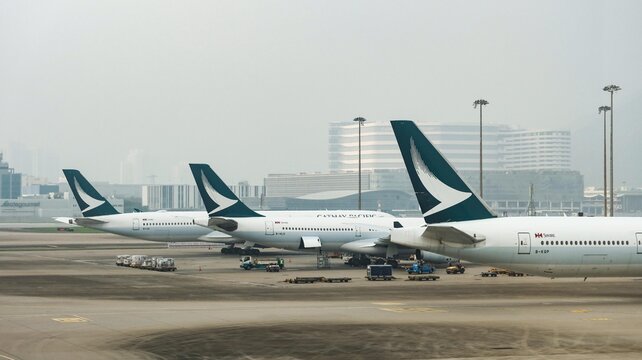 Hong Kong International Airport, Chek Lap Kok, Hong Kong- 18 Apr 2026: Cathay Pacific Airplane parked on the air side of the airport showing the logo on the wings of plane in daytime