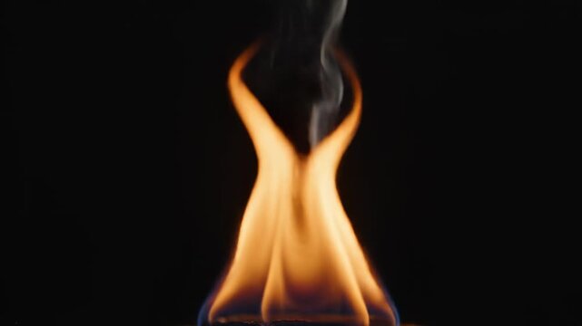 Radiant golden orange flames dance upwards, forming an ethereal silhouette against the deep sable darkness, showcasing the dynamic power and captivating beauty of fire's energy in a striking