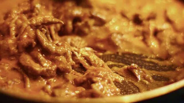 Stirring Beef Stroganoff With Wooden Spatula In Frying Pan. Italian Bolognese Cooking Process