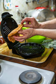 The hostess prepares the cakes heart waffle,old-fashioned way, using traditional European cuisine and utensils.