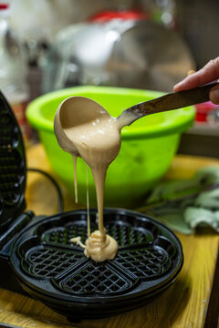 The hostess prepares the cakes heart waffle,old-fashioned way, using traditional European cuisine and utensils.