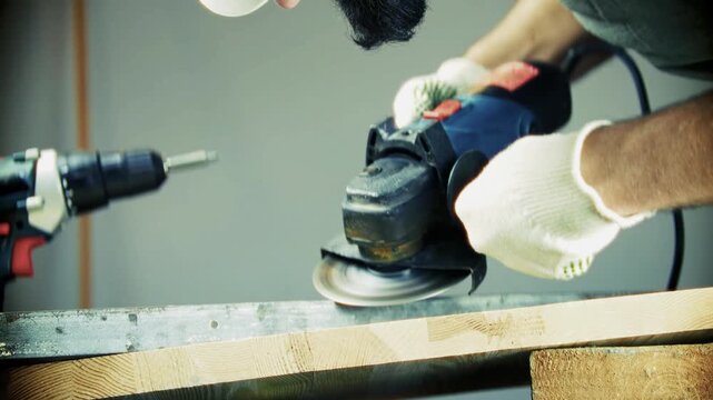 Using Angle Grinder on Metal Piece. Worker Cutting Steel Structure with Power Tool. Metalworking Process