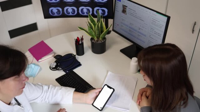 Doctor discusses treatment recommendations generated by artificial intelligence with young woman during medical consultation in modern healthcare clinic
