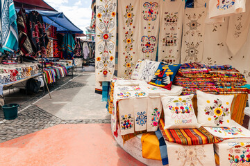 Fototapeta premium Otavalo Market Ponchos Plaza with Colorful Indigenous Textiles and Crafts, Ecuador