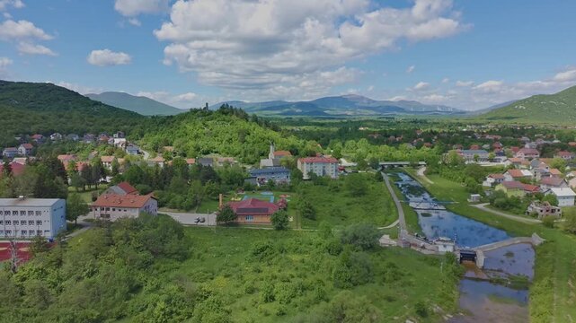 Aerial drone view of Gračac town surrounded by green mountains in Croatia