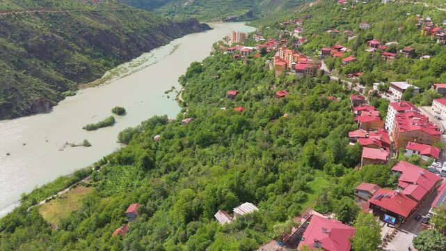 drone above  Kemaliye town and the Karasu River gorge, Turkey. Majestic drone landscape showing traditional houses nestled between steep limestone cliffs and the Euphrates