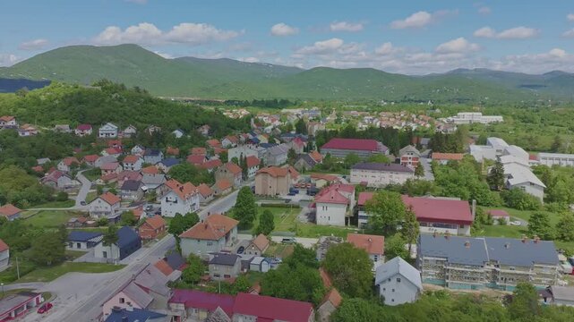 Aerial drone view of Gračac town surrounded by green mountains in Croatia