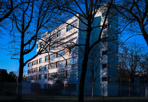 Modern residential building in Berlin Moabit with tree shadows