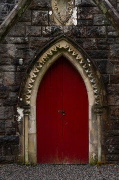 Old wooden red door in a church. St Conan's Kirk. Scotland