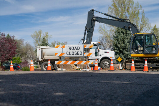 road closed - sign and barrier on a residential street for construction