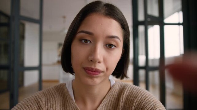 POV webcam angry Hispanic woman at home annoyed typing message on mobile phone point of view Latina female user influencer social media addict touch screen cellphone displeased girl online chatting