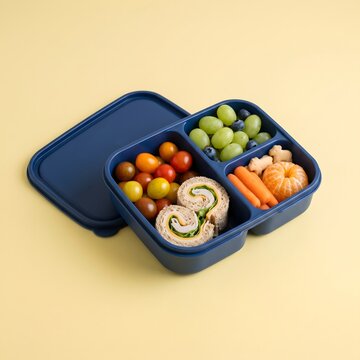 Healthy bento lunch box with sandwich rolls, fruits, and vegetables
