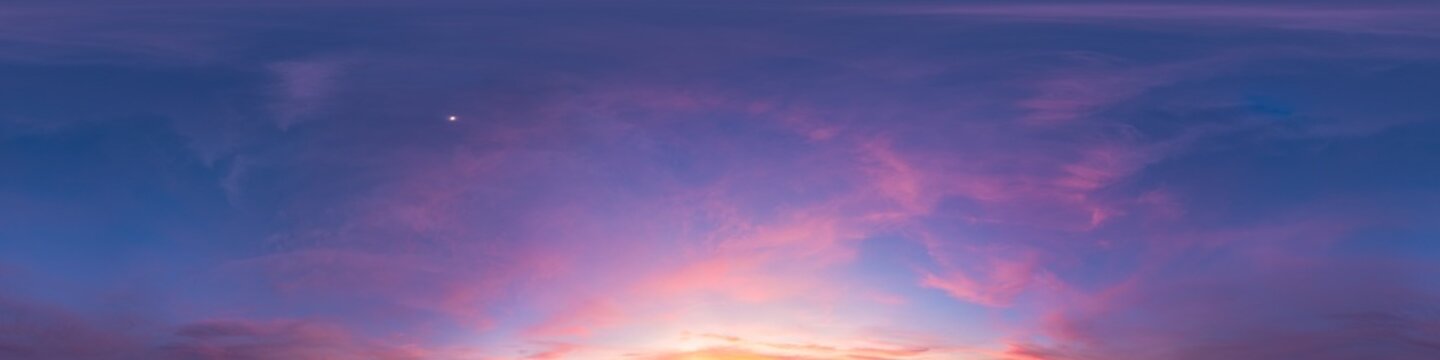 Sky sunset panorama showing beautiful pink and purple clouds over the horizon at twilight with copy space for background