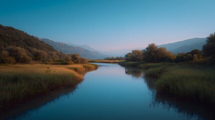 Fototapeta premium A quiet river winds through reeds and hills under soft evening light. Ideal for nature, conservation, travel, wellness, and environmental campaigns.