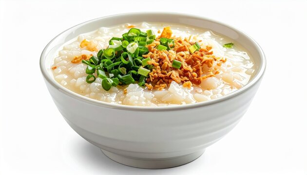 A bowl of traditional rice porridge topped with fresh chopped green onions and crispy fried shallots isolated on a white background image.
