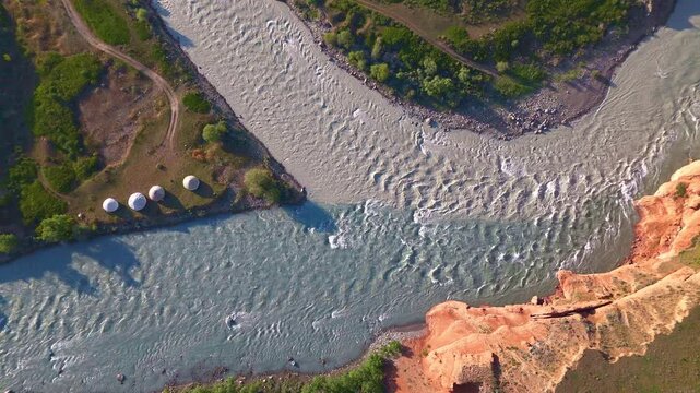 Aerial top-down view of yurt camp at Chong Naryn and Kichi Naryn confluence near Eki-Naryn, Kyrgyzstan