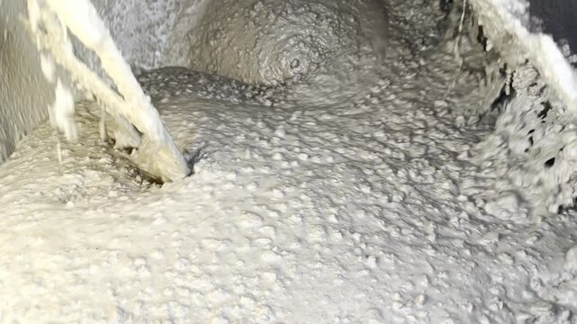 Mixing cement slurry in industrial mixer for building
