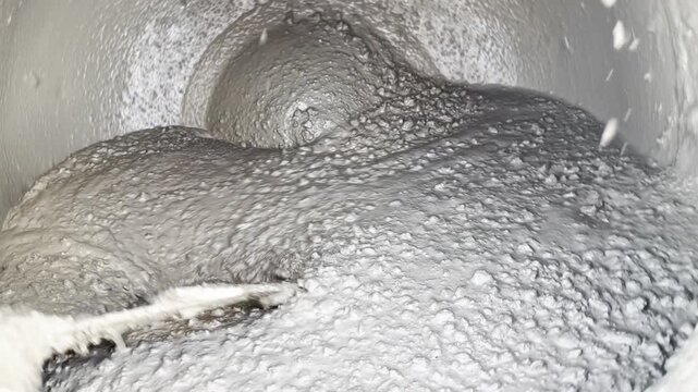 Mixing cement slurry in industrial mixer for building